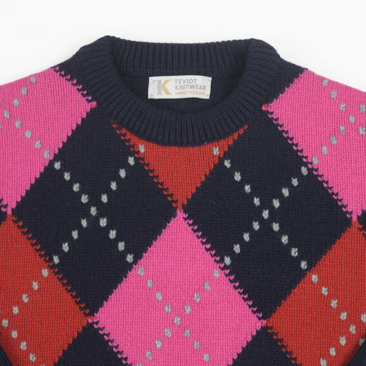 Round nek detail Women’s Chunky Argyle Jumper, colour Nero Navy with Punk Pink, Ruby Red and Flannel Grey Raker
